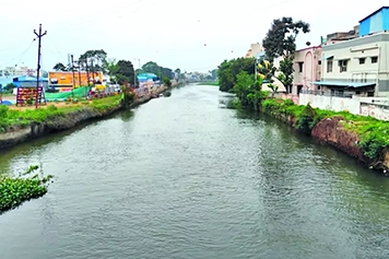 Scenic view of Uyyakondan Canal with easy access to convenient taxi services for smooth travel.